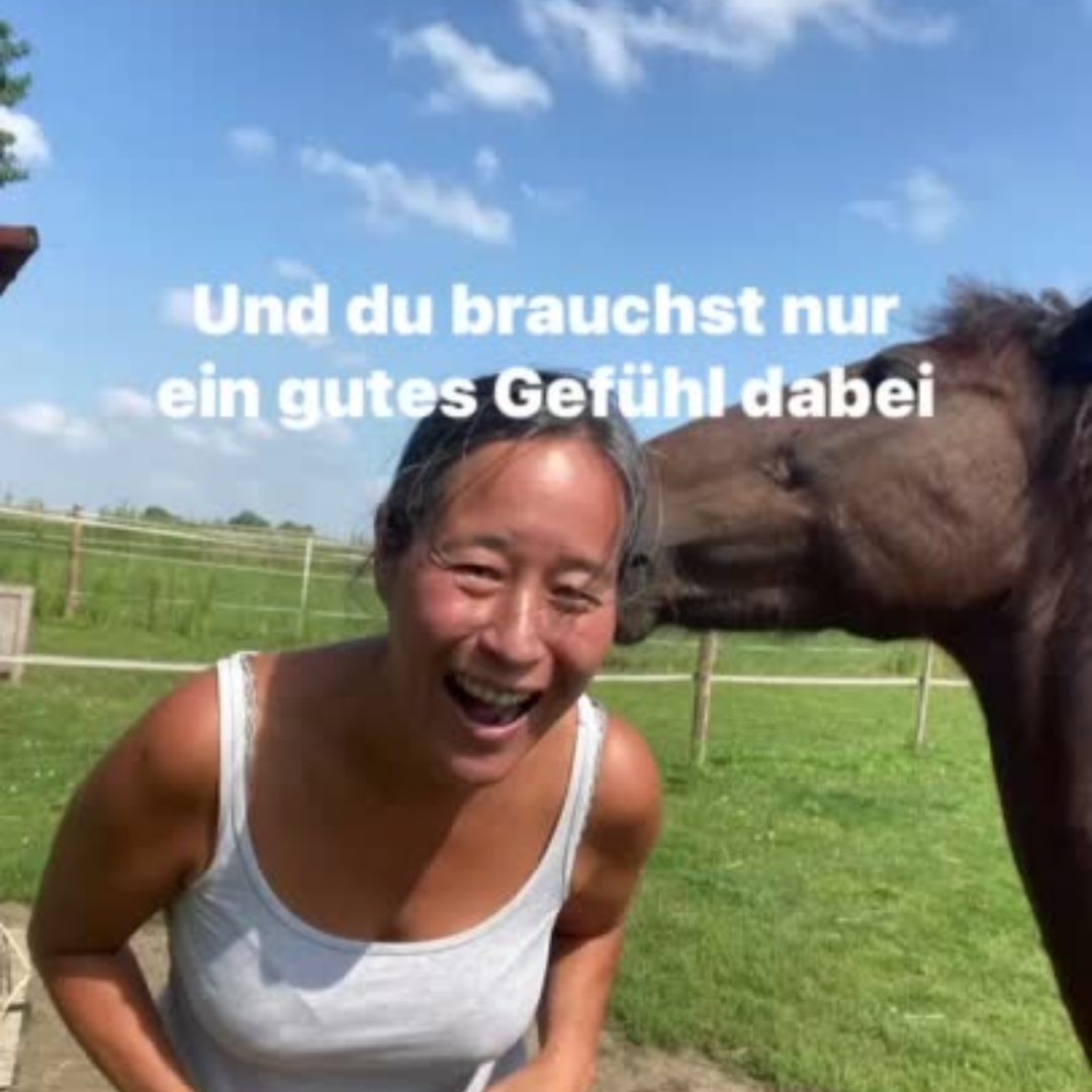 Frau lacht mit Pferd