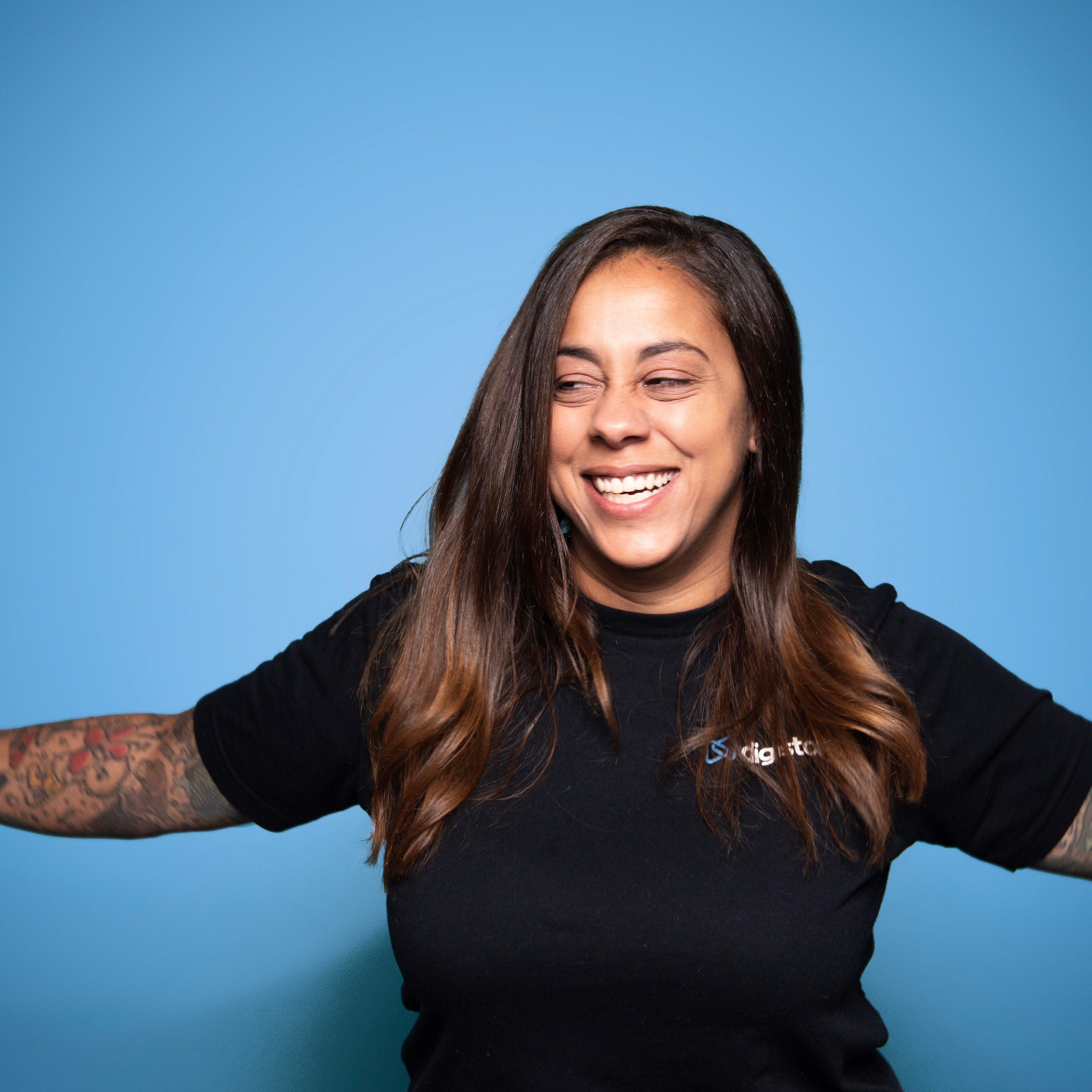 Coffee & Cash host Darcy Erickson smiling with her arms spread out.